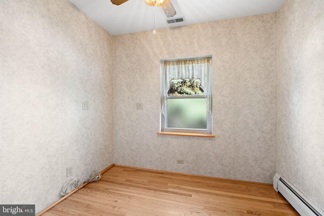 942 Paul St, Gloucester City, NJ 08030 - empty room featuring a baseboard heating unit, light wood-type flooring, and a ceiling fan
