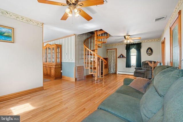942 Paul St, Gloucester City, NJ 08030 - living room featuring a ceiling fan, stairs, a baseboard heating unit, wallpapered walls, and wood finished floors