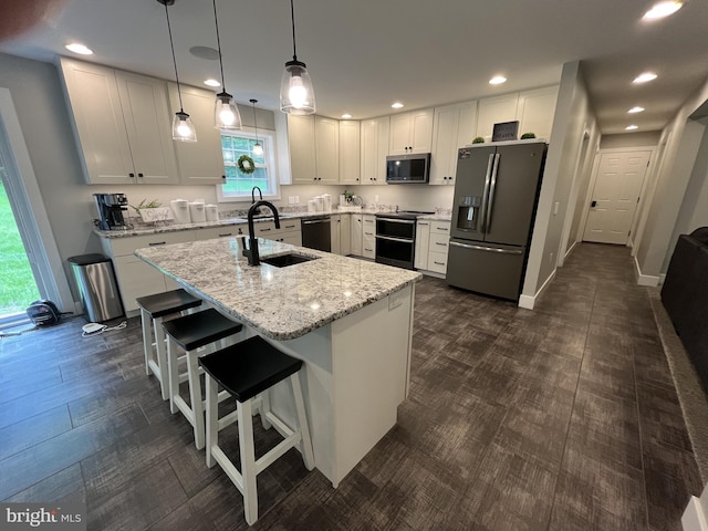 148 Five Points Rd, Mertztown, PA 19539 - kitchen with stainless steel appliances, plenty of natural light, recessed lighting, light stone counters, and a kitchen island with sink