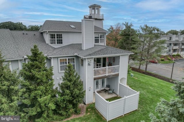2902 Waters Edge Dr Unit 261, Newark, DE 19702 - back of house with a balcony, a chimney, roof with shingles, and a patio area