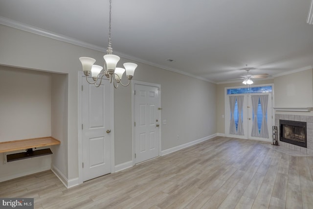 2902 Waters Edge Dr Unit 261, Newark, DE 19702 - unfurnished dining area with light wood-style flooring, a ceiling fan, a chandelier, ornamental molding, and a tiled fireplace