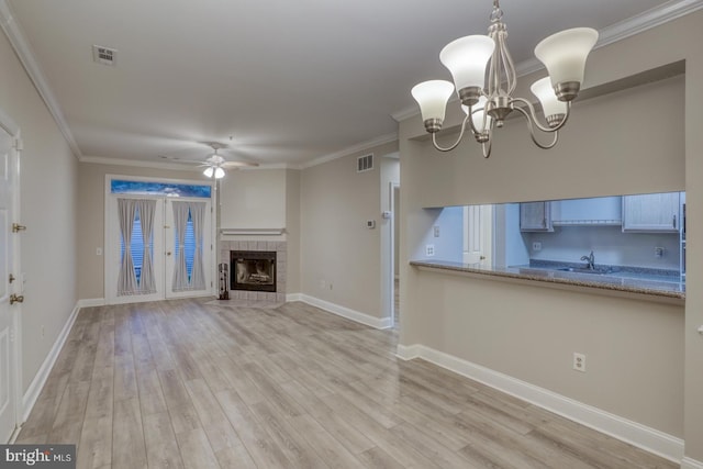 2902 Waters Edge Dr Unit 261, Newark, DE 19702 - unfurnished living room with ceiling fan, light wood-style floors, a fireplace, a chandelier, and crown molding