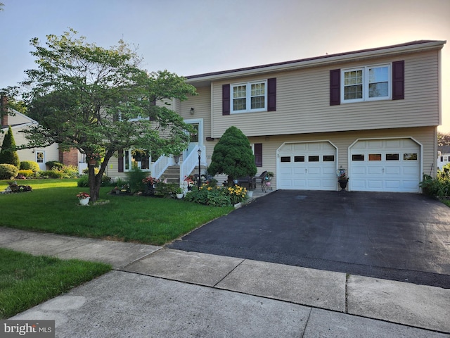 32 Devonshire Dr, Reading, PA 19610 - bi-level home featuring asphalt driveway, a garage, a front yard, and stairs