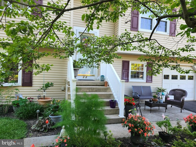 32 Devonshire Dr, Reading, PA 19610 - back of property with outdoor lounge area, a garage, and a patio area