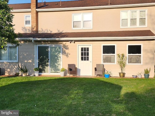 32 Devonshire Dr, Reading, PA 19610 - rear view of property with a yard, a shingled roof, and a chimney
