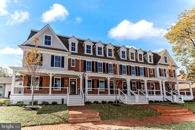 738 S Matlack St, West Chester, PA 19382 - view of front facade featuring a porch, brick siding, and a front lawn