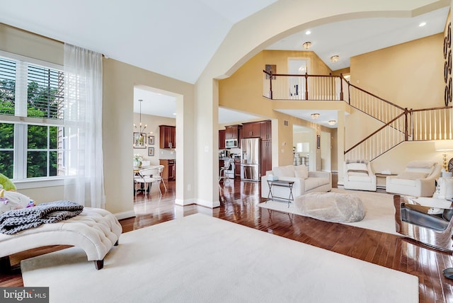 3017 Bainbridge Dr, Lansdale, PA 19446 - living room with hardwood / wood-style floors, stairs, arched walkways, a chandelier, and high vaulted ceiling