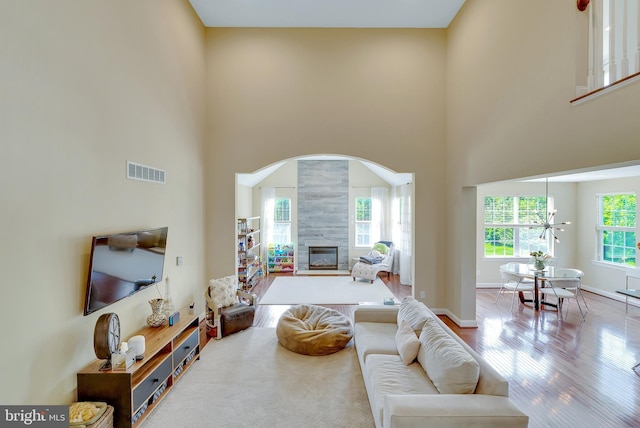 3017 Bainbridge Dr, Lansdale, PA 19446 - living room with a fireplace, a high ceiling, wood finished floors, and arched walkways