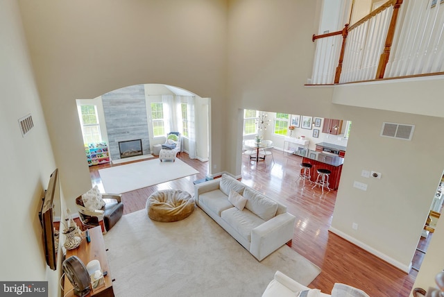 3017 Bainbridge Dr, Lansdale, PA 19446 - living area with a towering ceiling, arched walkways, wood finished floors, and a fireplace