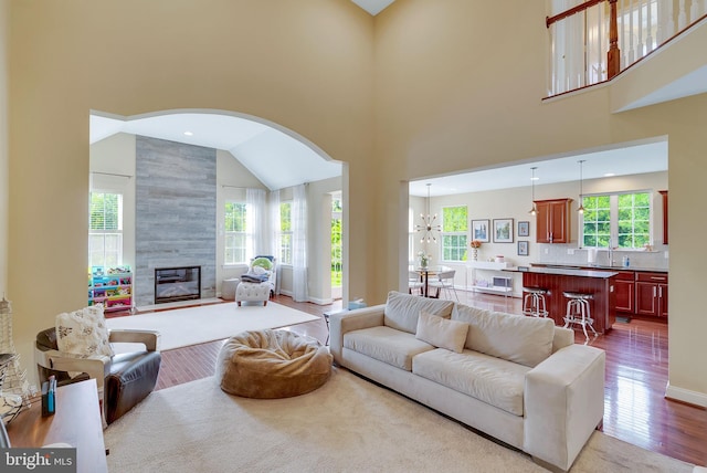 3017 Bainbridge Dr, Lansdale, PA 19446 - living room featuring a towering ceiling, arched walkways, wood finished floors, and a fireplace