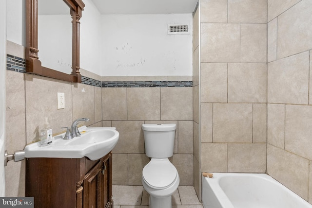 1847 Gerritt St, Philadelphia, PA 19146 - bathroom featuring a tub, vanity, tile walls, and a wainscoted wall