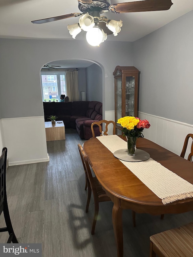 3432 Hartel Ave, Philadelphia, PA 19136 - dining space featuring arched walkways, wood finished floors, a wainscoted wall, and a chandelier