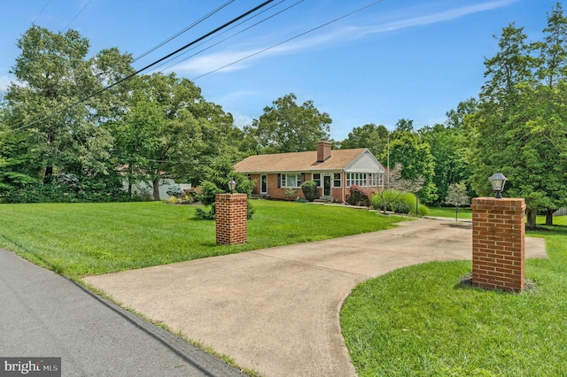 29 Cedar Dr, Sterling, VA 20164 - view of front facade with a chimney, a front lawn, and driveway
