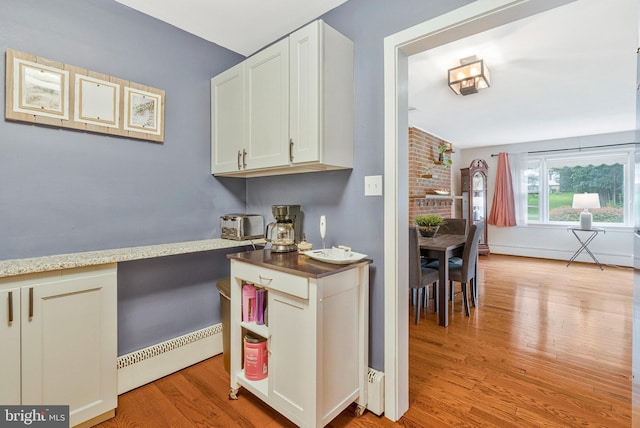 29 Cedar Dr, Sterling, VA 20164 - kitchen with light wood-style flooring, a baseboard radiator, and white cabinets