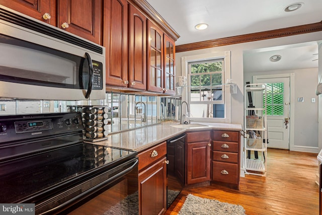114 Walsh Rd, Lansdowne, PA 19050 - kitchen featuring electric range, stainless steel microwave, dishwashing machine, glass insert cabinets, and light wood-type flooring