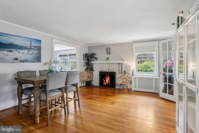 114 Walsh Rd, Lansdowne, PA 19050 - dining area featuring radiator, light wood-style floors, healthy amount of natural light, and crown molding