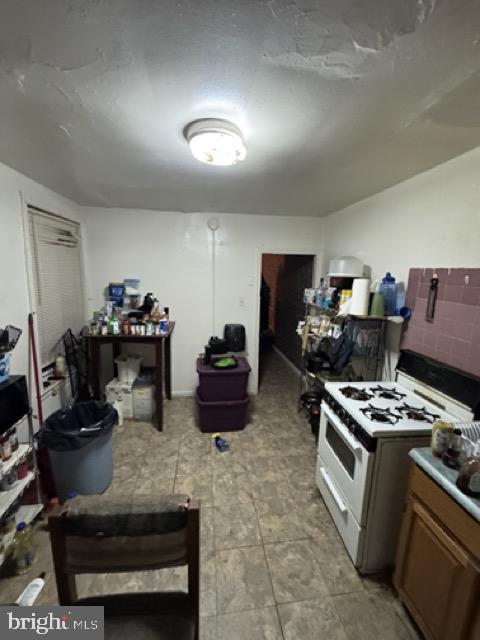 3230 N Lee St, Philadelphia, PA 19134 - kitchen with gas range gas stove and brown cabinets