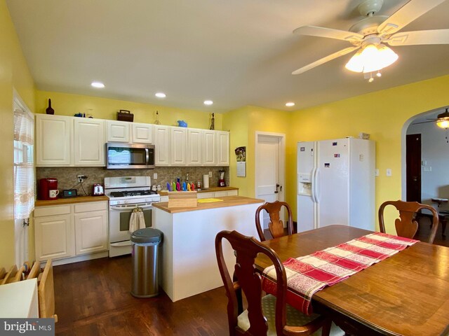 2634 Yorkway, Baltimore, MD 21222 - kitchen with white appliances, ceiling fan, dark wood finished floors, white cabinets, and arched walkways