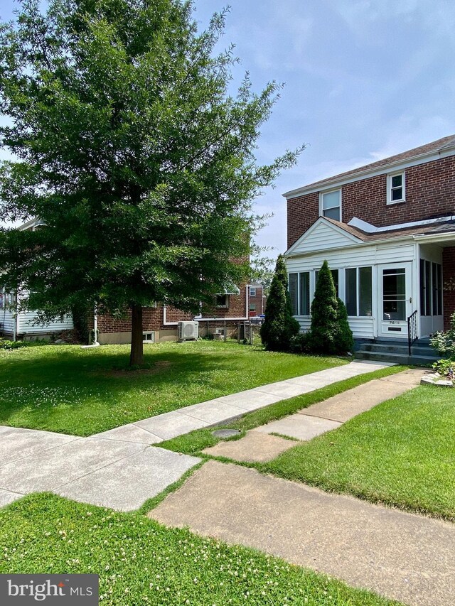 2634 Yorkway, Baltimore, MD 21222 - view of front facade featuring a front lawn, brick siding, and entry steps