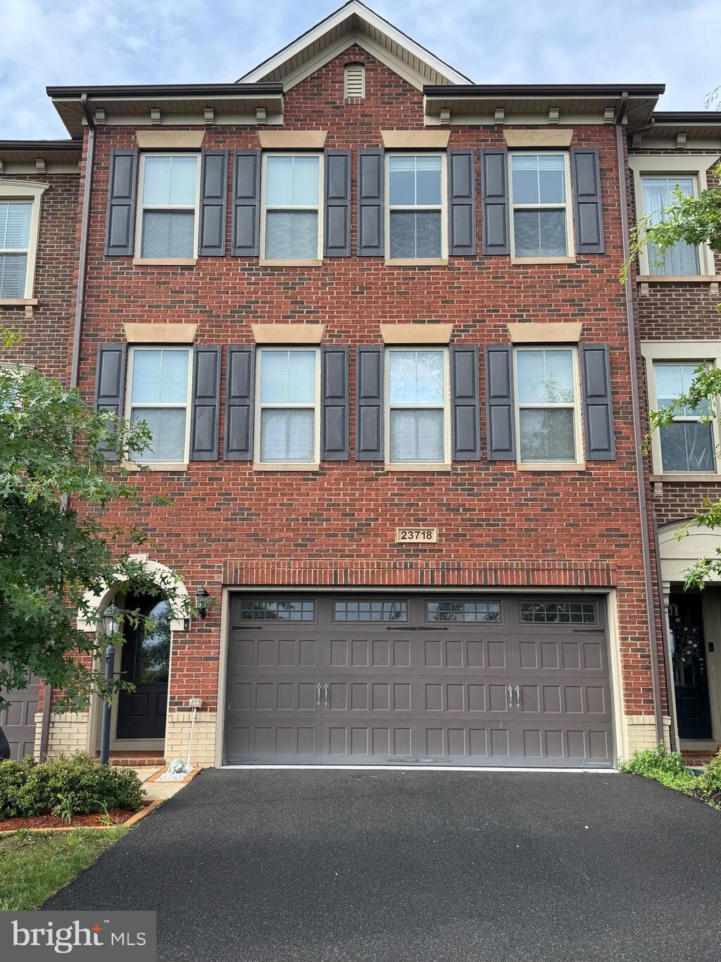 23718 Sailfish Sq, Brambleton, VA 20148 - multi unit property with brick siding, asphalt driveway, and an attached garage