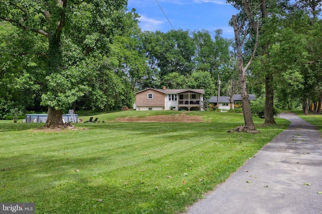 1945 Shenandoah Springs Ln, Elkton, VA 22827 - view of front of property with a garage, a front yard, a chimney, asphalt driveway, and view of wooded area