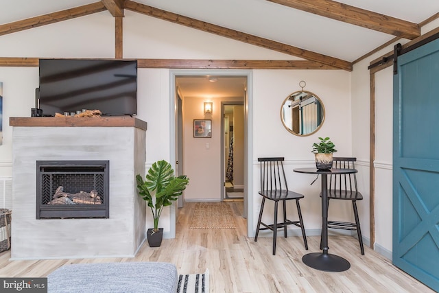 1945 Shenandoah Springs Ln, Elkton, VA 22827 - living area featuring a barn door, wood finished floors, and a glass covered fireplace