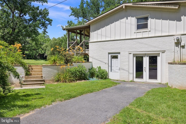 1945 Shenandoah Springs Ln, Elkton, VA 22827 - view of home's exterior with brick siding, board and batten siding, stairs, and a yard
