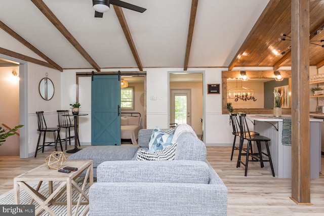 1945 Shenandoah Springs Ln, Elkton, VA 22827 - living area featuring a barn door, light wood-style flooring, ceiling fan, and a chandelier