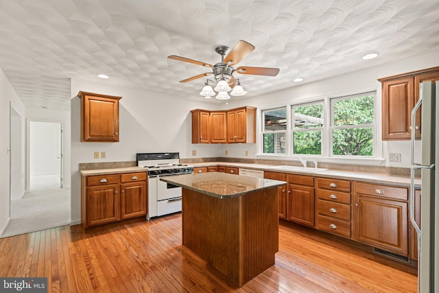421 Old Stage Rd, Lewisberry, PA 17339 - kitchen featuring white appliances, brown cabinetry, light wood-style flooring, a ceiling fan, and recessed lighting