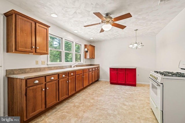 421 Old Stage Rd, Lewisberry, PA 17339 - kitchen with gas range gas stove, brown cabinetry, a ceiling fan, and a textured ceiling