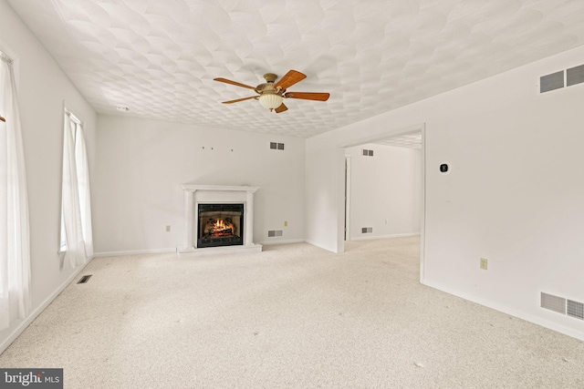 421 Old Stage Rd, Lewisberry, PA 17339 - unfurnished living room with a lit fireplace, a ceiling fan, and carpet