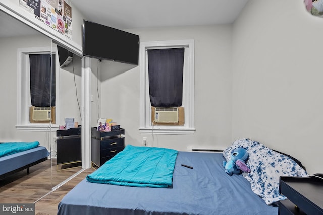 400 E Vernon Rd, Philadelphia, PA 19119 - bedroom with wood finished floors, a closet, cooling unit, and baseboard heating