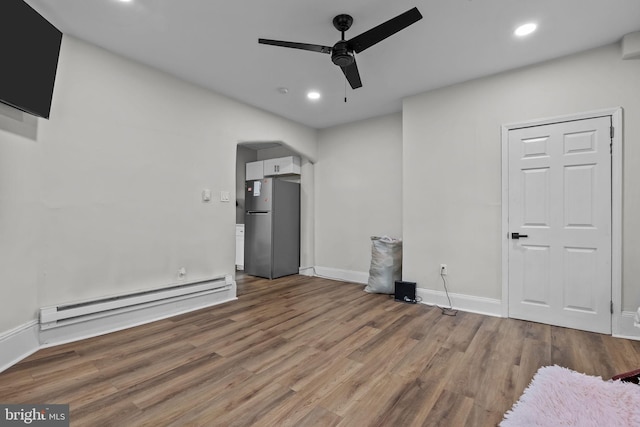 400 E Vernon Rd, Philadelphia, PA 19119 - unfurnished bedroom with freestanding refrigerator, a baseboard radiator, wood finished floors, arched walkways, and recessed lighting