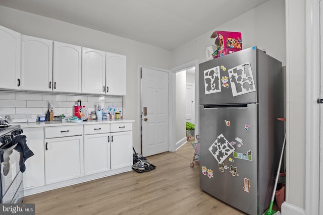 400 E Vernon Rd, Philadelphia, PA 19119 - kitchen featuring freestanding refrigerator, gas stove, white cabinets, and light countertops