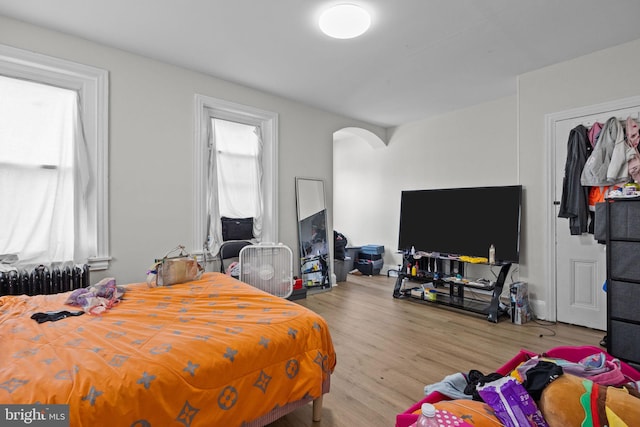400 E Vernon Rd, Philadelphia, PA 19119 - bedroom with radiator, arched walkways, and wood finished floors