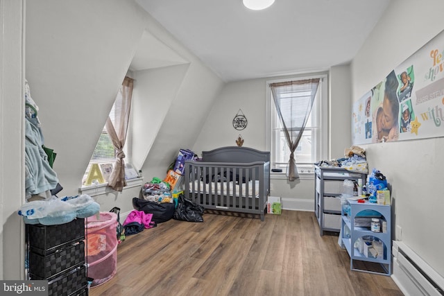 400 E Vernon Rd, Philadelphia, PA 19119 - bedroom with multiple windows, wood finished floors, and a baseboard radiator