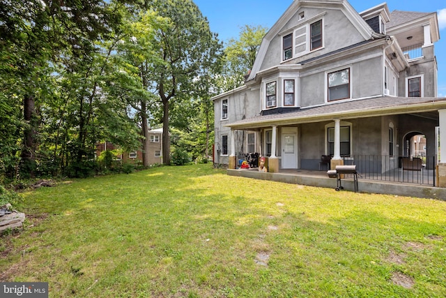 400 E Vernon Rd, Philadelphia, PA 19119 - rear view of property featuring stucco siding, covered porch, and a lawn