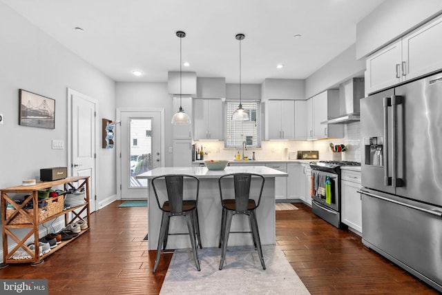 1837 N Palethorp St, Philadelphia, PA 19122 - kitchen with appliances with stainless steel finishes, wall chimney exhaust hood, a kitchen bar, a center island, and light countertops