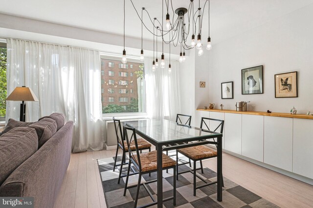 4301 Massachusetts Ave NW Unit A212, Washington, DC 20016 - dining area with light wood-style floors and a chandelier