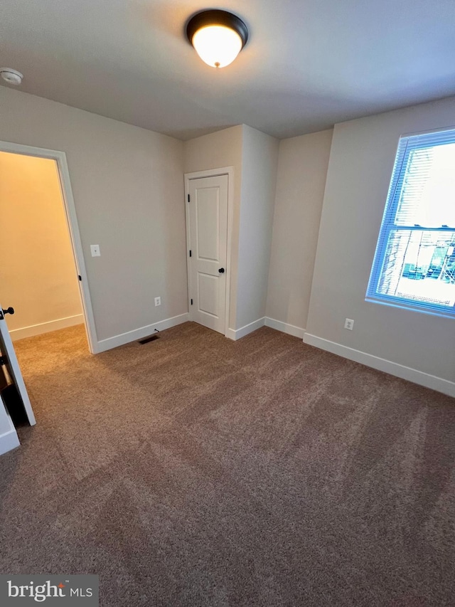 432 Bonsal St, Baltimore, MD 21224 - carpeted spare room with baseboards and a smoke detector