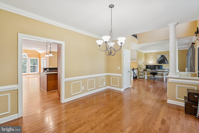 1340 Mountain View Rd, Stafford, VA 22554 - unfurnished dining area featuring decorative columns, wainscoting, light wood-style floors, a chandelier, and crown molding
