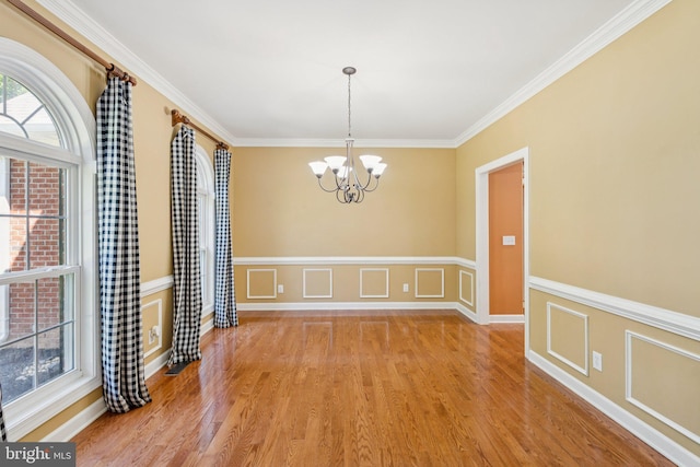 1340 Mountain View Rd, Stafford, VA 22554 - unfurnished dining area featuring a chandelier, light wood-style floors, ornamental molding, and wainscoting