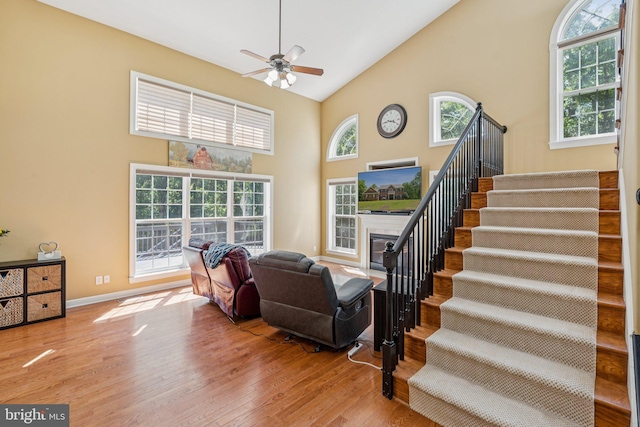 1340 Mountain View Rd, Stafford, VA 22554 - living area with high vaulted ceiling, stairs, wood finished floors, ceiling fan, and a fireplace