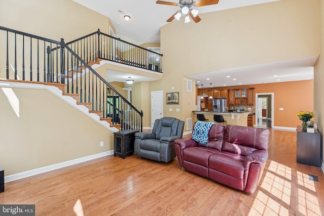 1340 Mountain View Rd, Stafford, VA 22554 - living room with light wood-style floors, a ceiling fan, stairway, a high ceiling, and recessed lighting