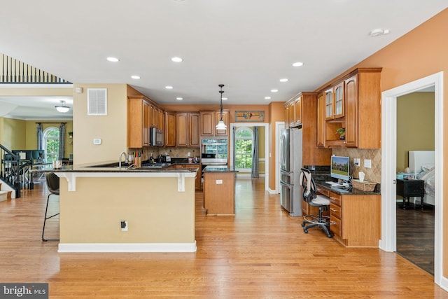 1340 Mountain View Rd, Stafford, VA 22554 - kitchen featuring stainless steel appliances, light wood-style flooring, a kitchen bar, an office area, and recessed lighting