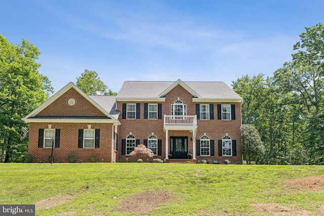 1340 Mountain View Rd, Stafford, VA 22554 - georgian-style home with a front lawn, a balcony, and brick siding