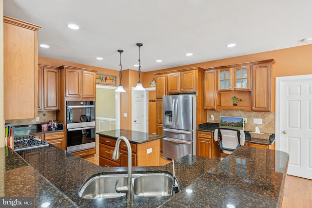 1340 Mountain View Rd, Stafford, VA 22554 - kitchen with stainless steel appliances, brown cabinets, decorative backsplash, decorative light fixtures, and a kitchen island