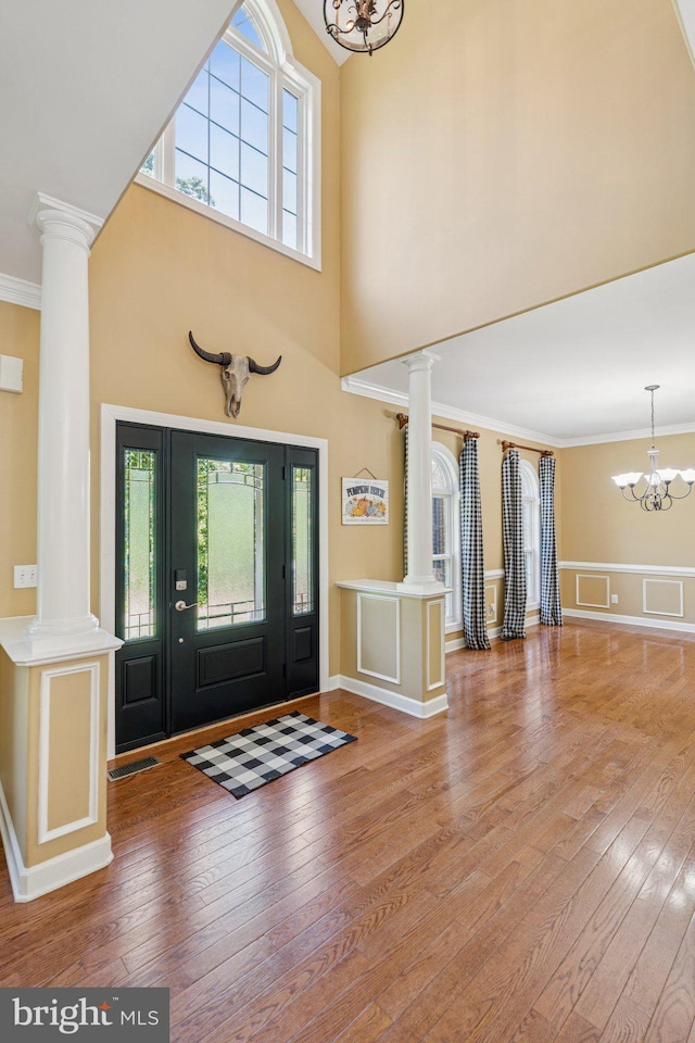 1340 Mountain View Rd, Stafford, VA 22554 - foyer with a chandelier, decorative columns, ornamental molding, hardwood / wood-style floors, and a high ceiling