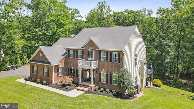 1340 Mountain View Rd, Stafford, VA 22554 - colonial inspired home featuring a balcony, a front lawn, brick siding, and roof with shingles