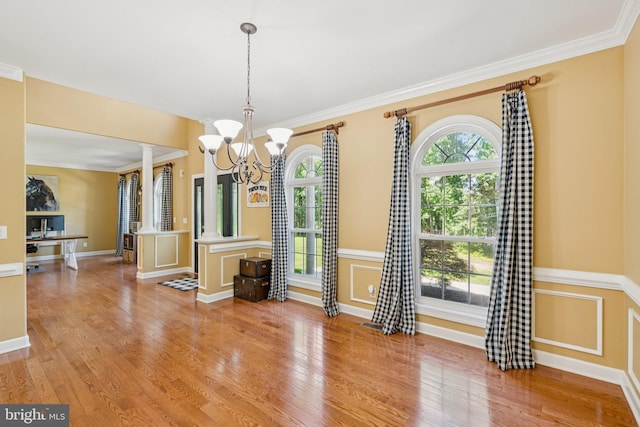 1340 Mountain View Rd, Stafford, VA 22554 - unfurnished dining area with decorative columns, a chandelier, light wood-style flooring, and ornamental molding